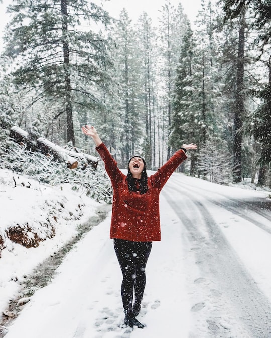 woman in pink jacket standing on snow covered ground in Tahoe United States