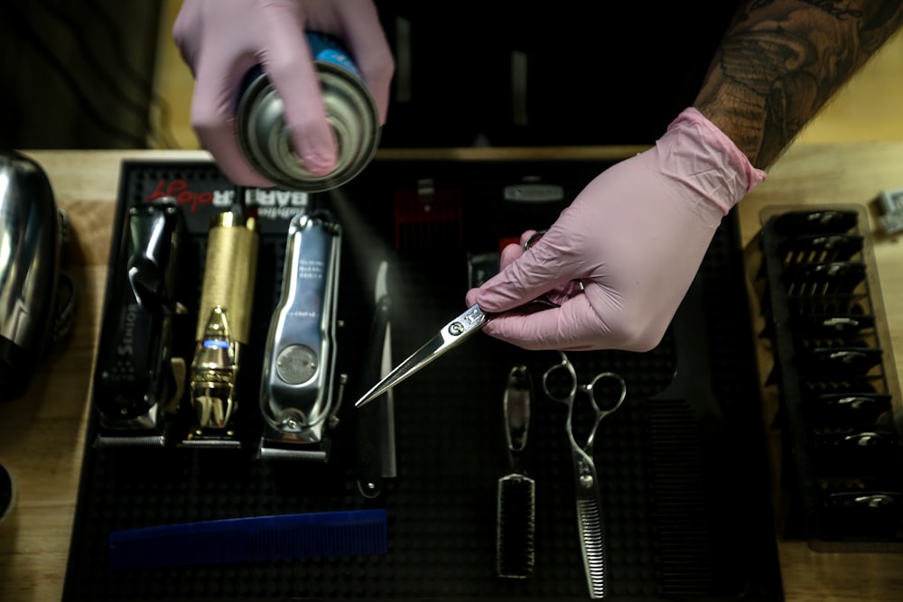 person holding stainless steel tool