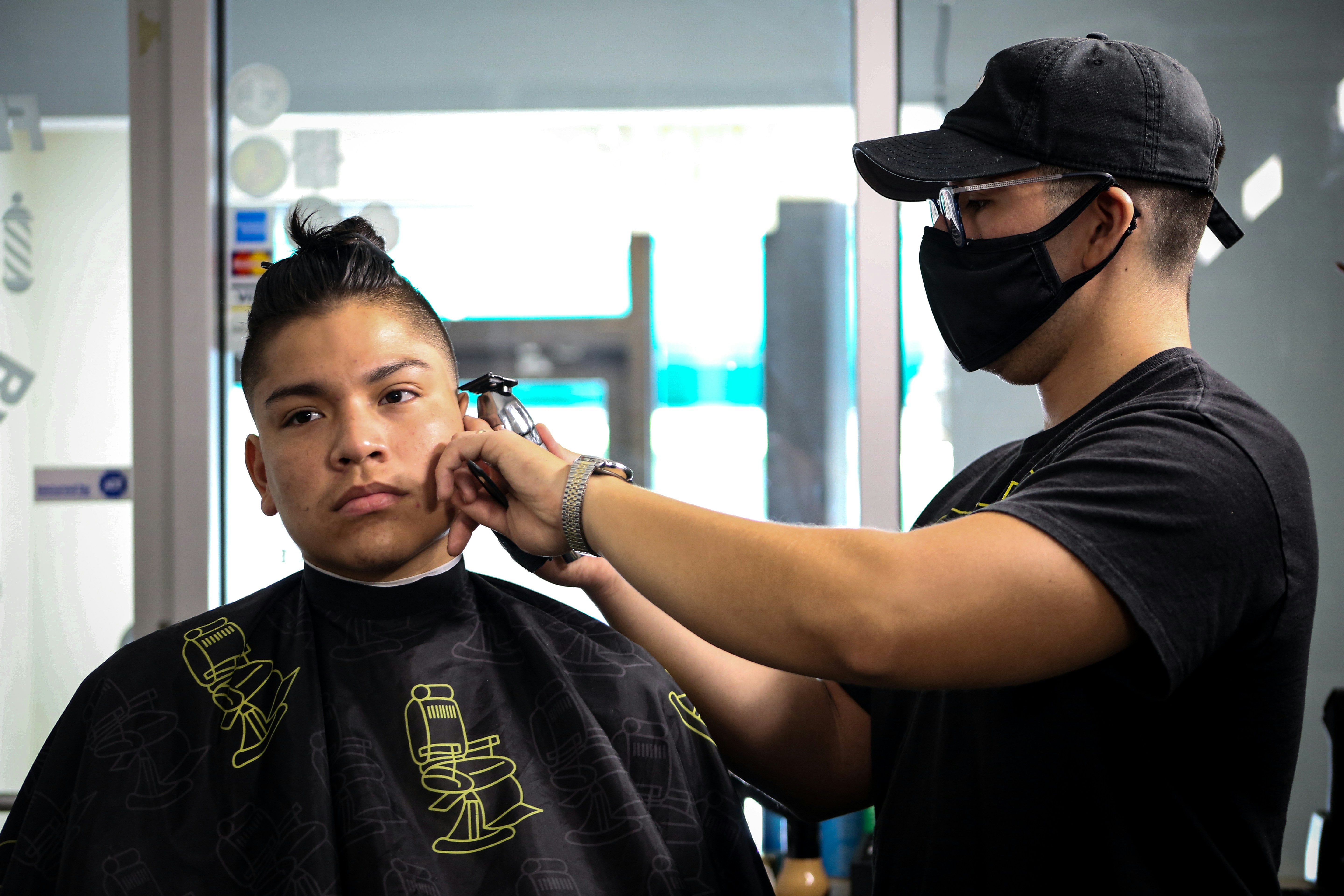 man in black crew neck t-shirt wearing black cap