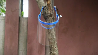 Close-up of disposable face shields hanging ready for shipment.