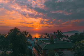 A vibrant sunset view over Langkawi's lush rainforest and coastline.
