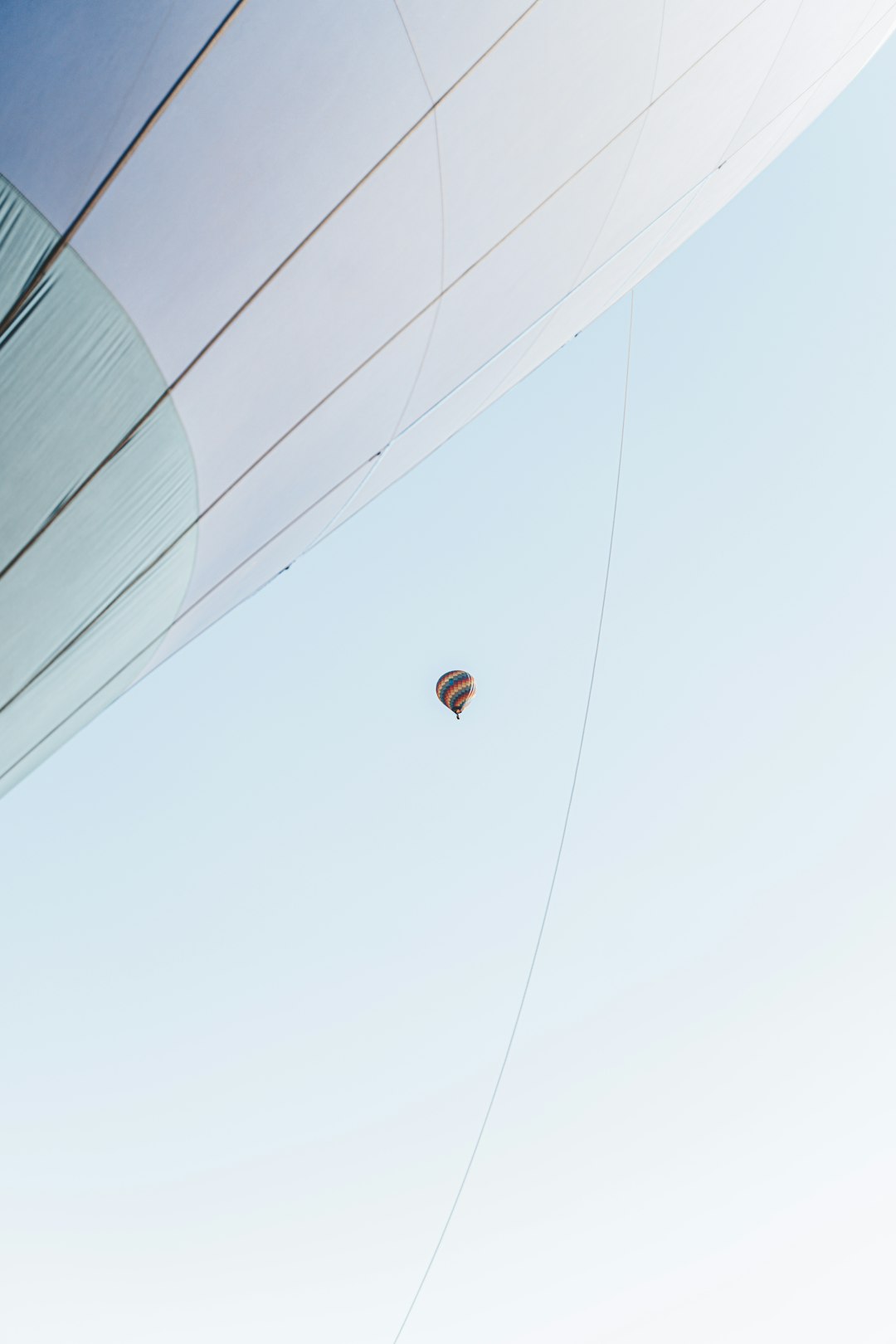 person in red shirt and black pants riding on hot air balloon