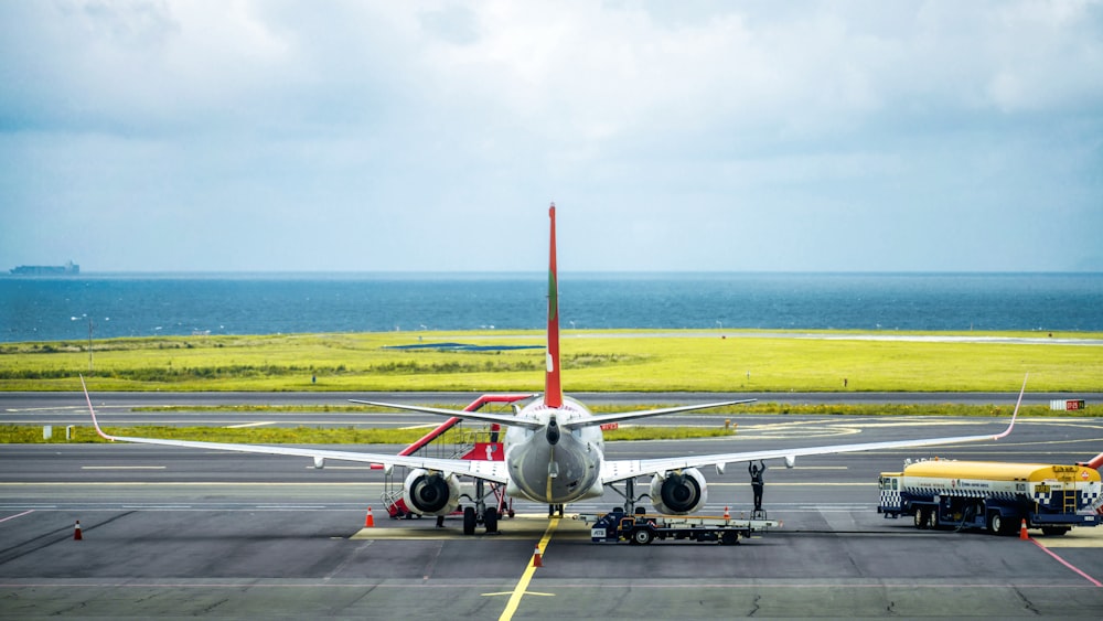 white and red airplane on airport during daytime