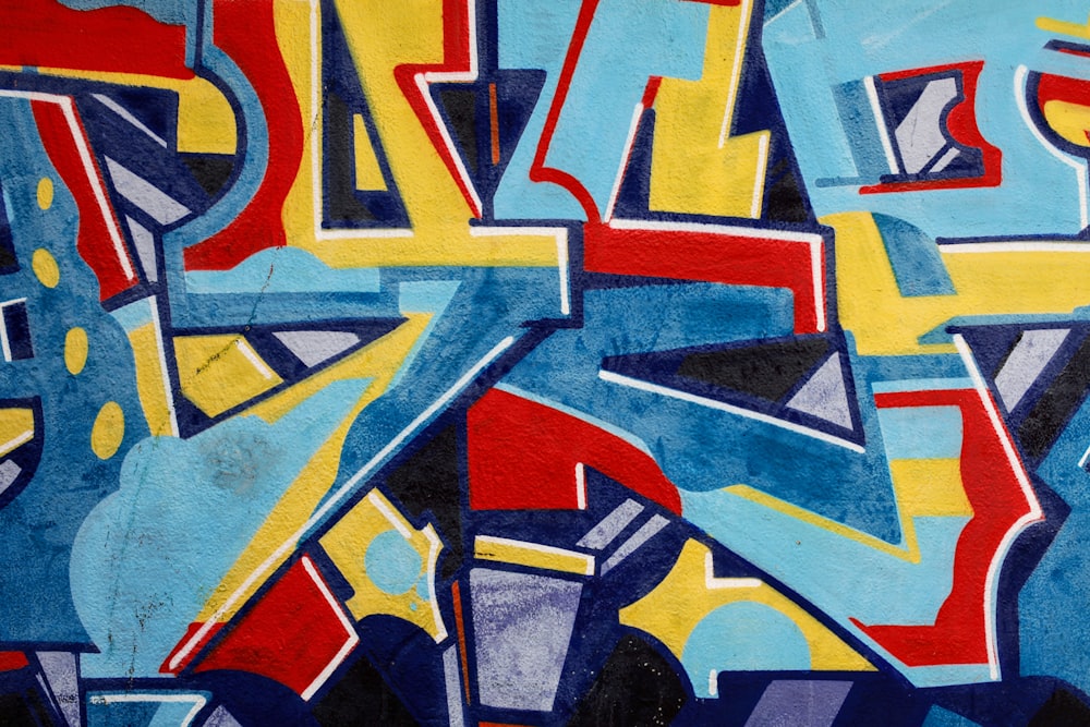 a painting of blue, yellow, and red letters