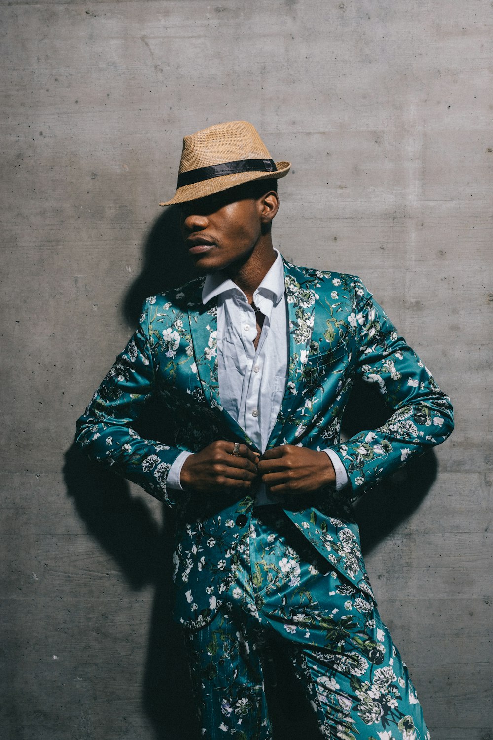 man in blue and white floral long sleeve shirt wearing brown hat