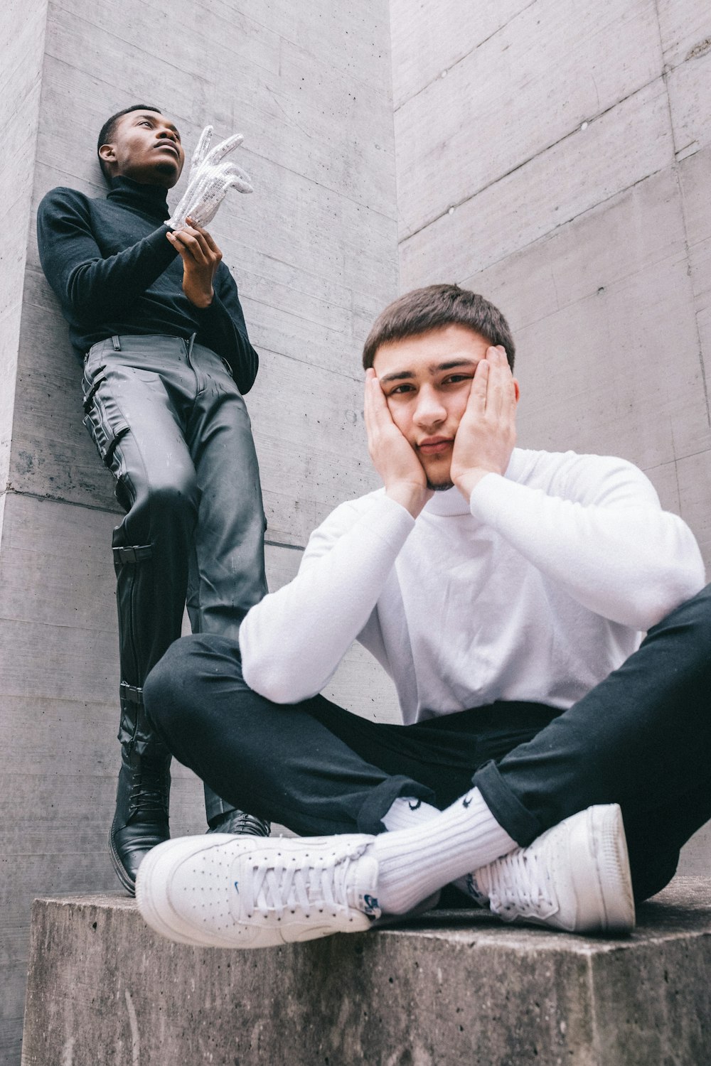 man in white dress shirt and black dress pants sitting on white plastic armchair