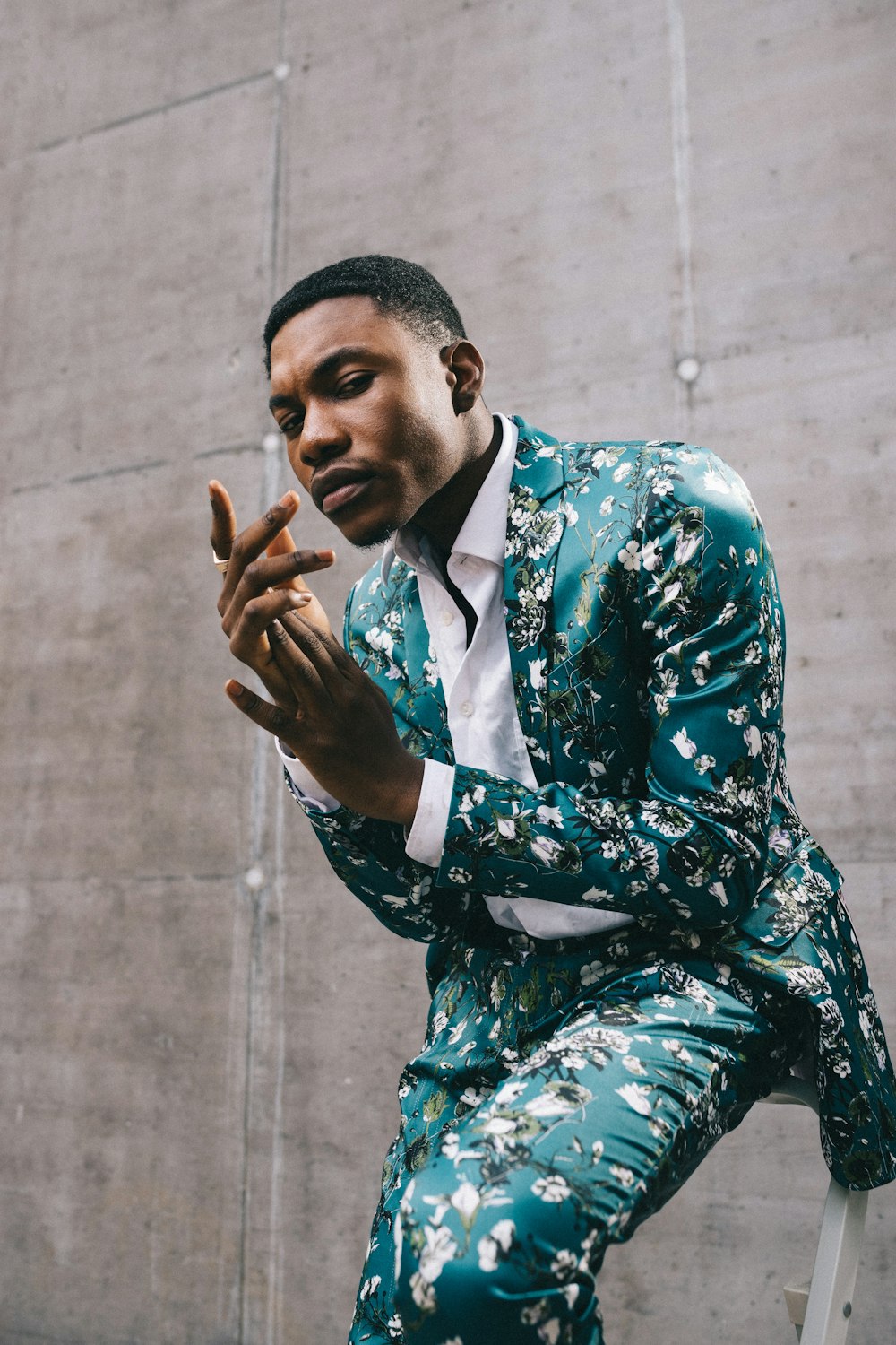 man in black and white floral suit