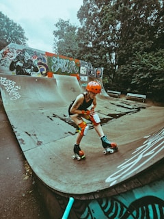 boy in red and white shirt riding on black skateboard during daytime
