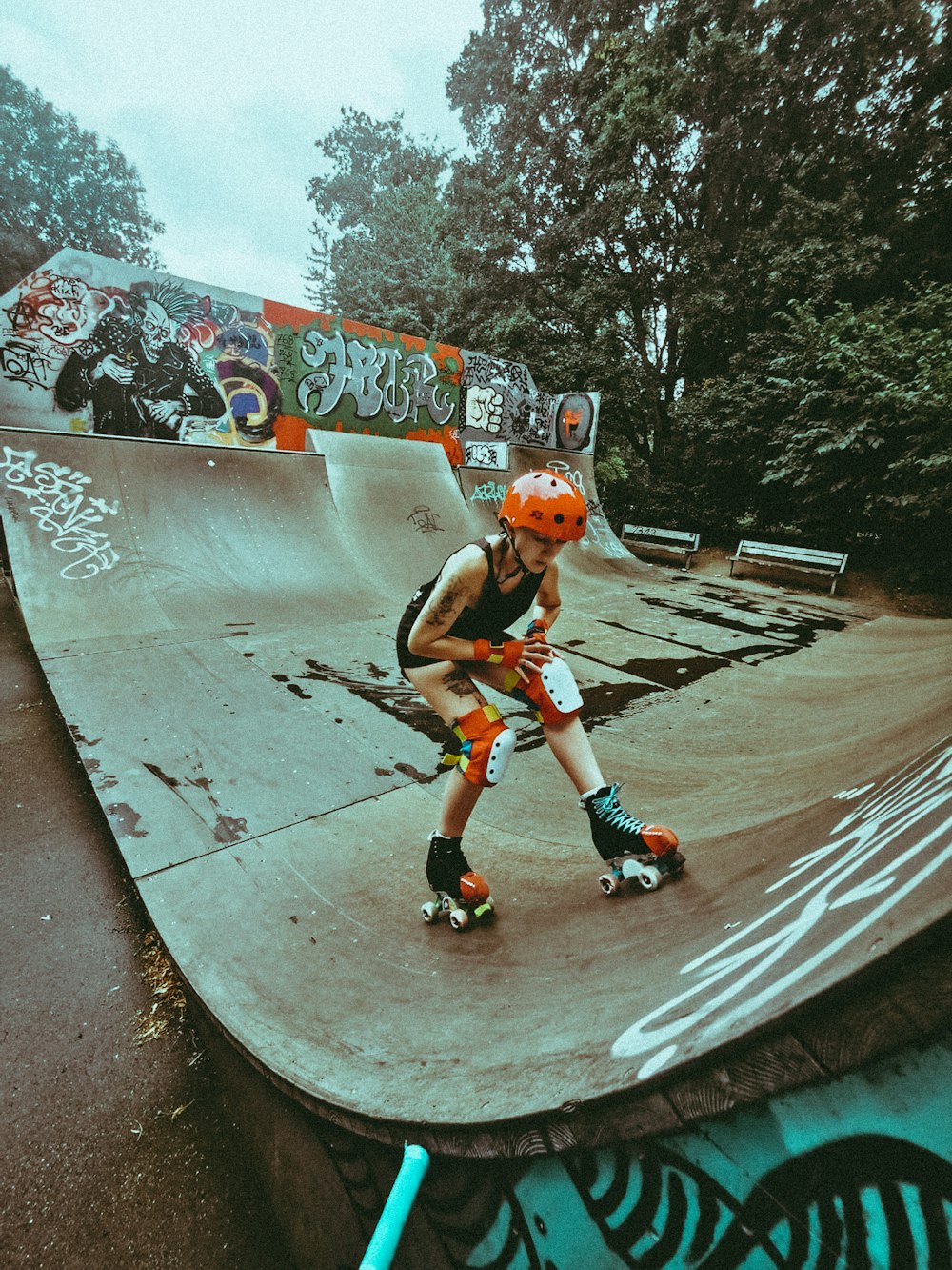 boy in red and white shirt riding on black skateboard during daytime