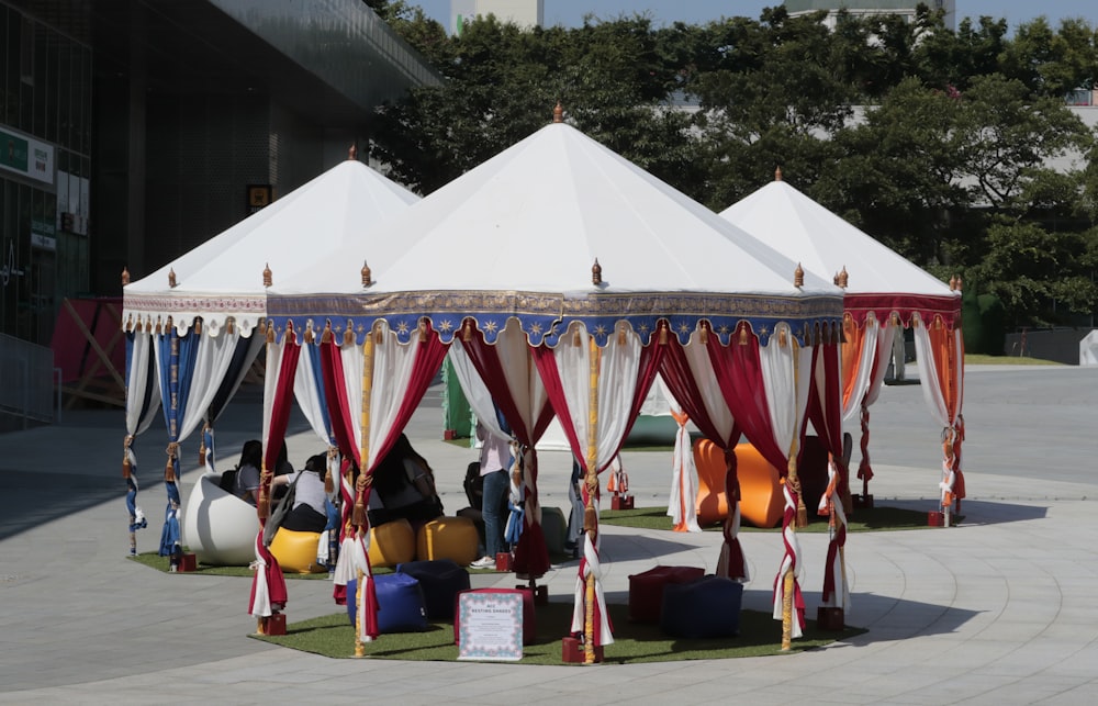 white and red tent on green grass field during daytime