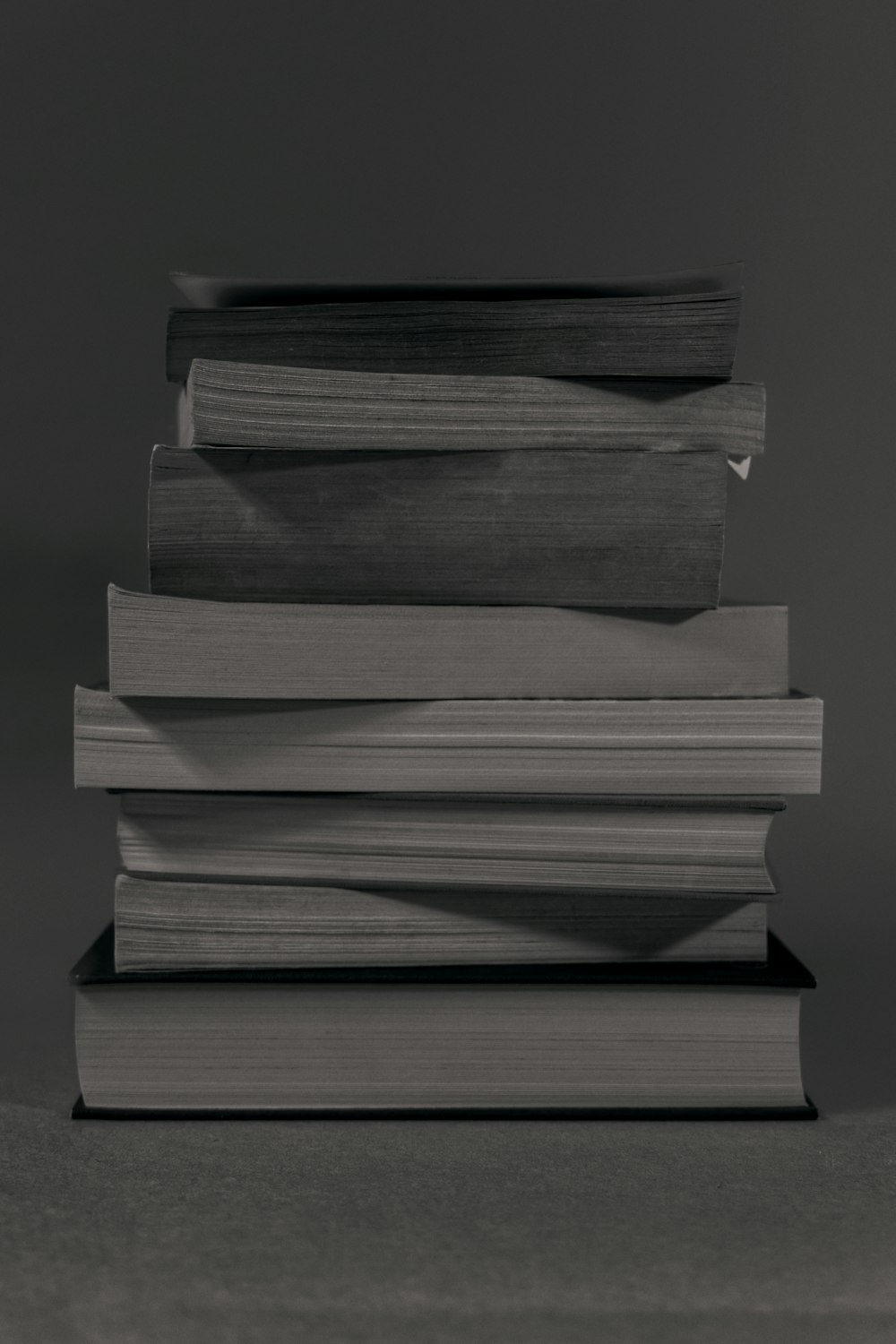 stack of books on black table