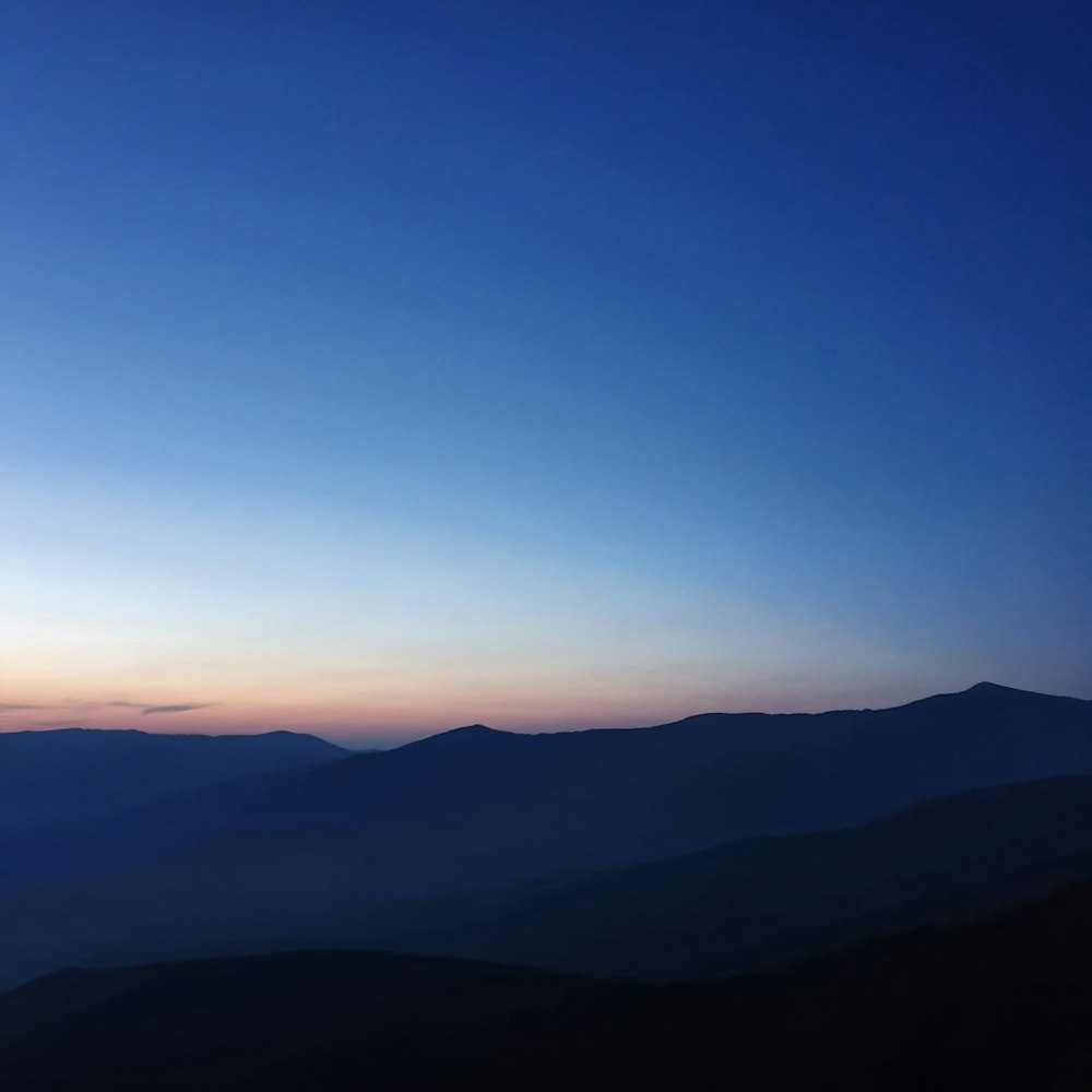 silhouette of mountains during sunset