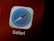 A close-up of an app icon displaying a compass with a red and blue needle, surrounded by a gray border. The app's name, 'Safari', is visible underneath in white text against a dark red background.