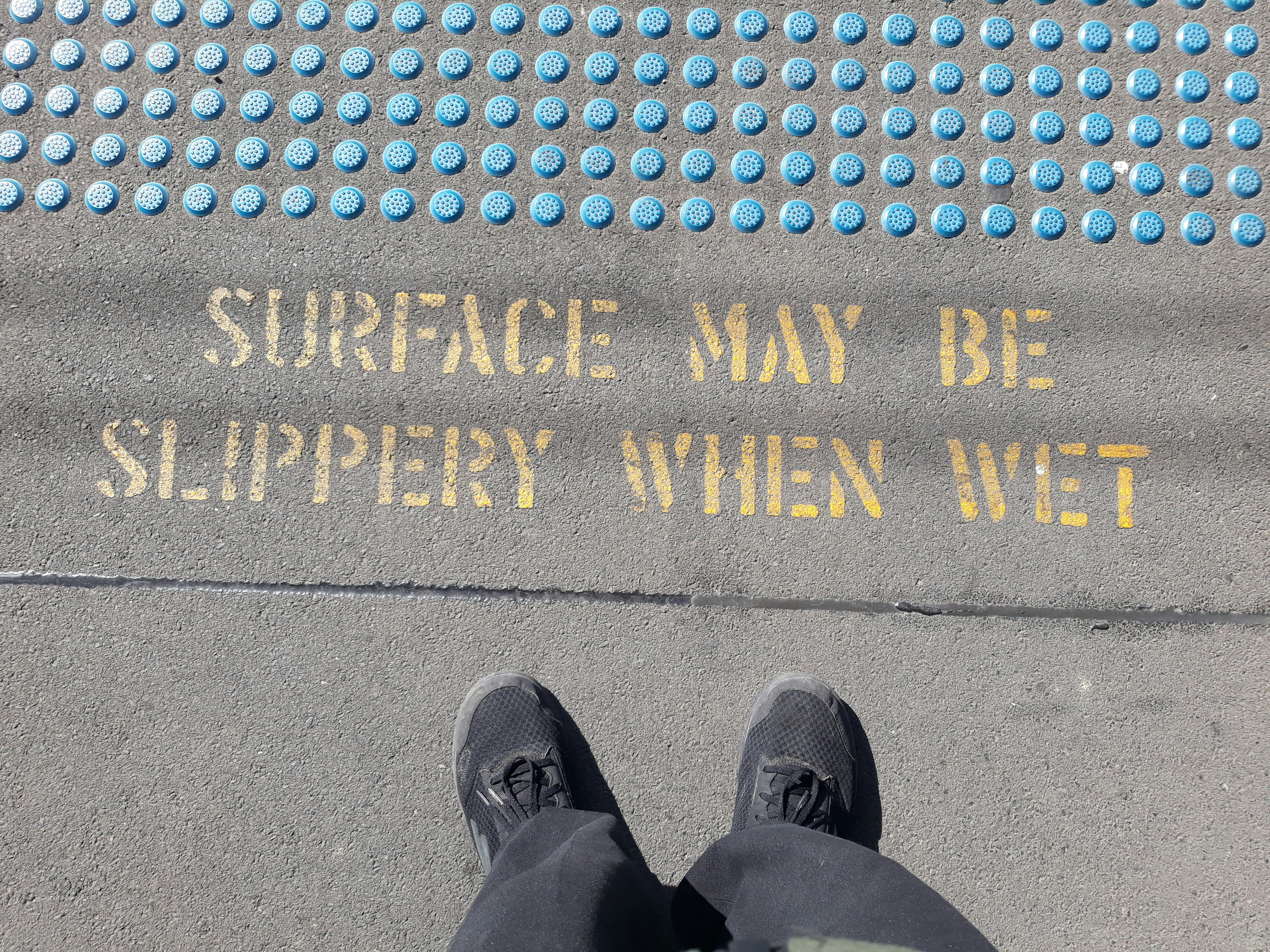 person in black leather shoes standing on blue and gold happy new year