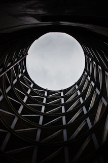 brown wooden frame under white clouds during daytime