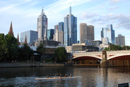brown bridge over river near city buildings during daytime in Melbourne City Centre Australia