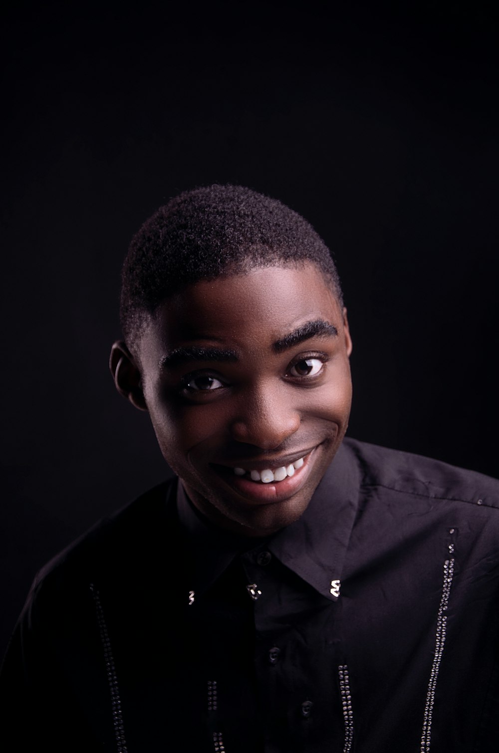 smiling man in black leather jacket