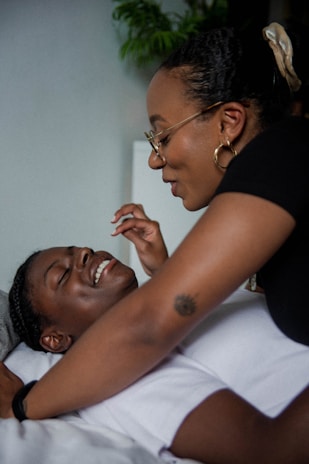 Smiling man and woman enjoying a relaxing self-care routine together.