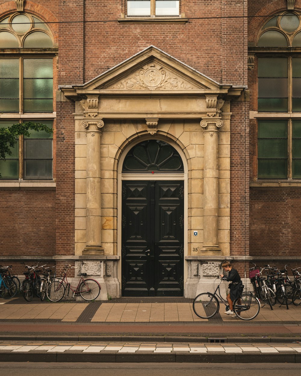 black bicycle parked beside brown concrete building during daytime