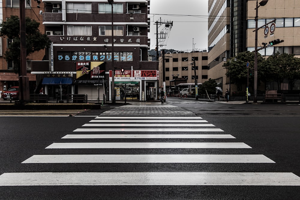 pedestrian lane in front of brown and white building during night time