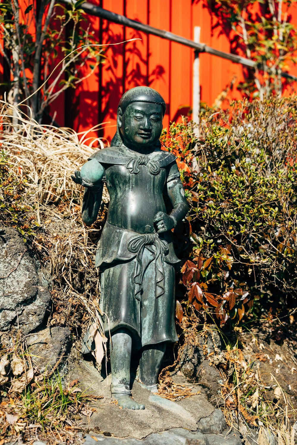 black statue of man on brown rock