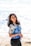 woman in white and blue floral shirt and blue denim shorts