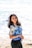 woman in white and blue floral shirt and blue denim shorts