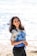 woman in white and blue floral shirt and blue denim shorts