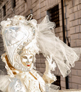 A classic Venetian masquerade mask adorned with gold and black patterns.