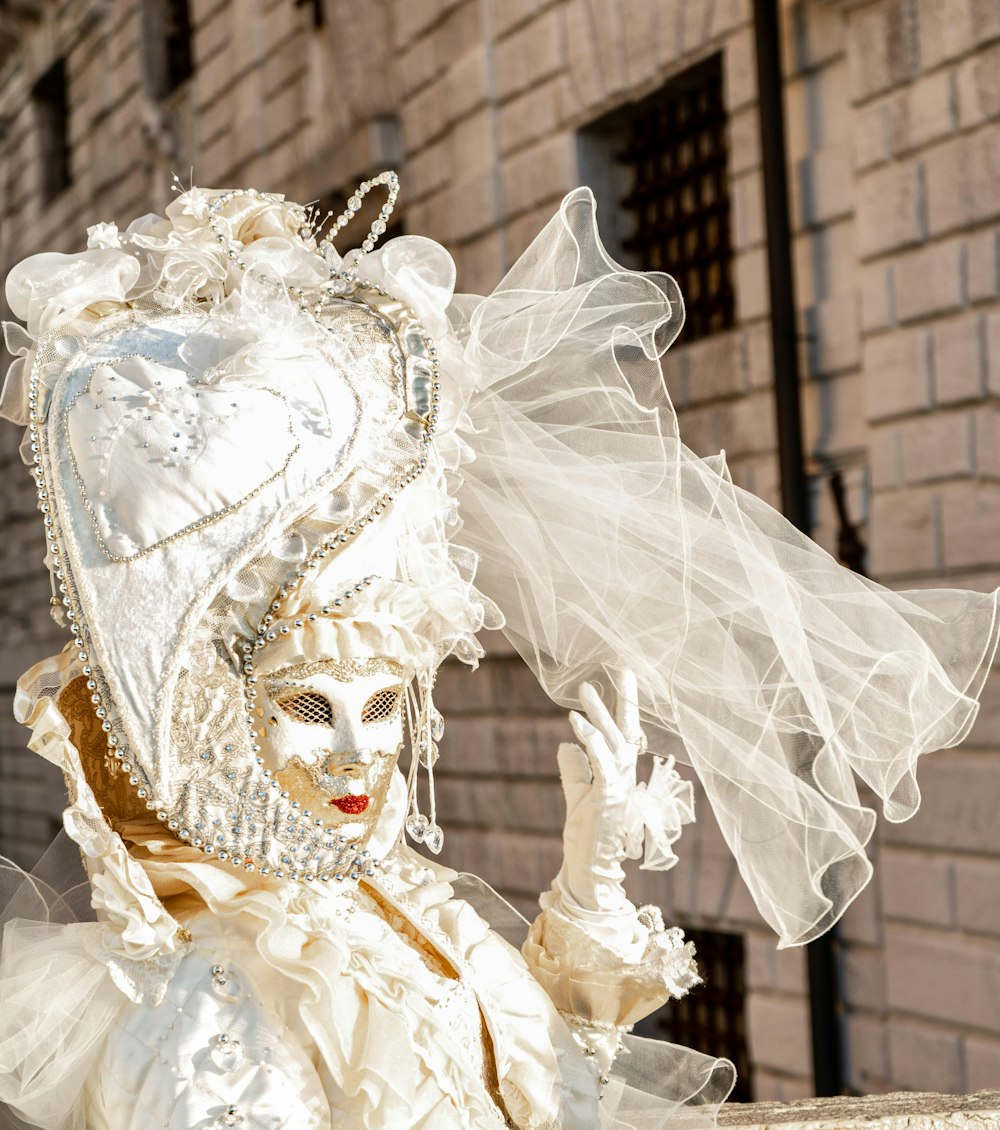 white and gold mask on white textile