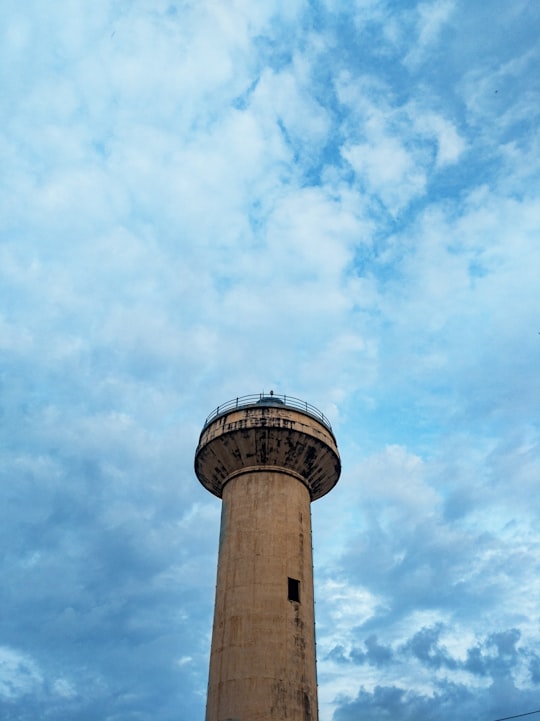 white and brown concrete tower under blue sky during daytime in Bangalore India