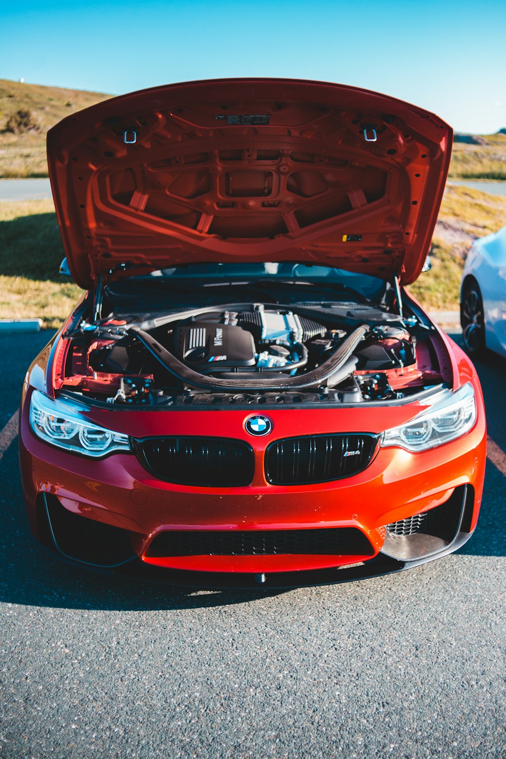 red bmw m 3 on road during daytime