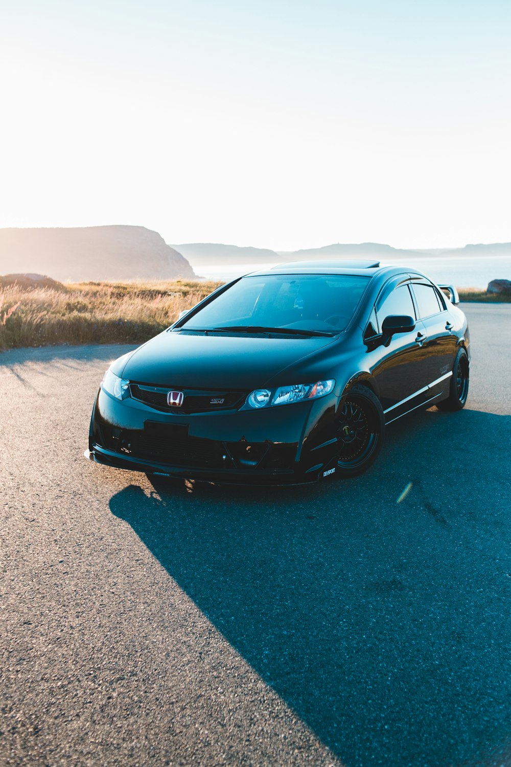 black honda car on gray asphalt road during daytime