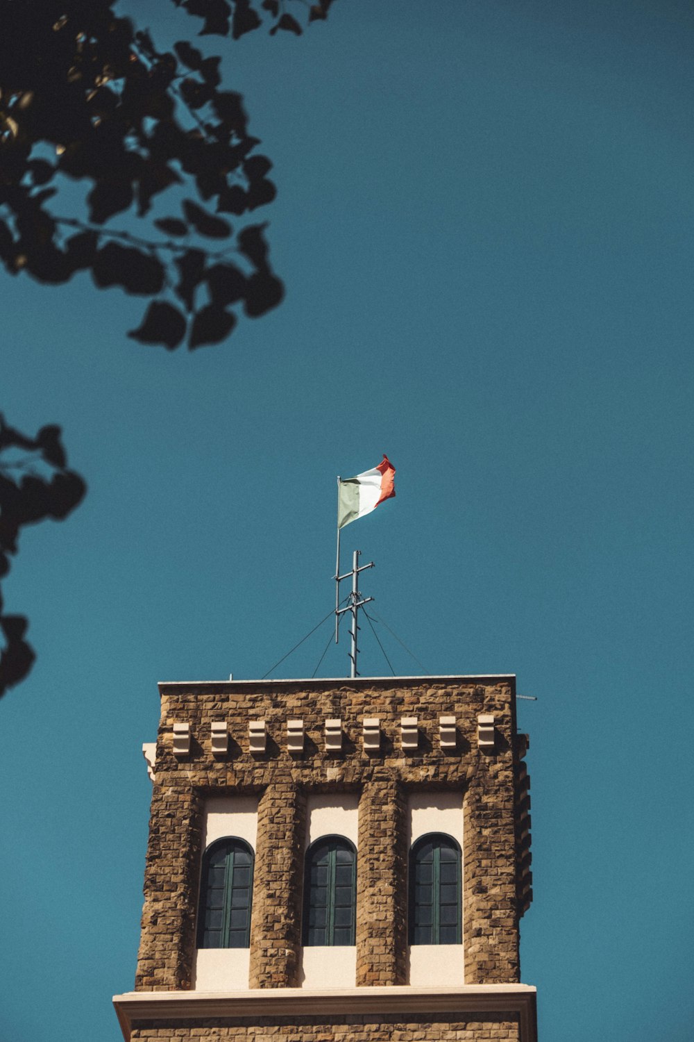 brown concrete building with flag of us a during daytime