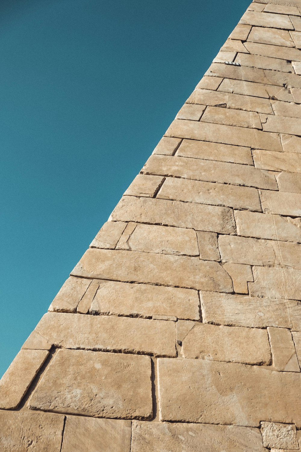 brown brick wall under blue sky during daytime