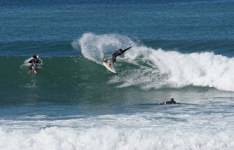 man surfing on sea waves during daytime