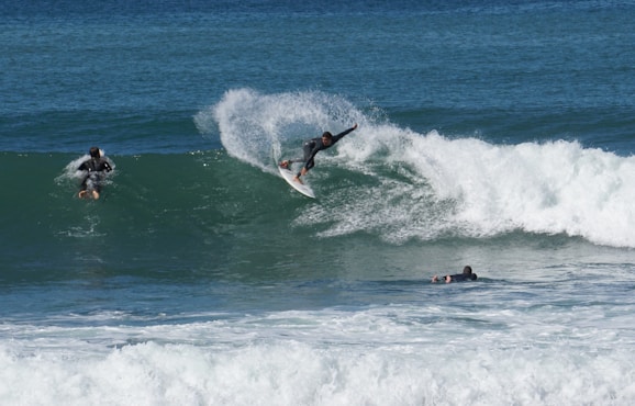 man surfing on sea waves during daytime