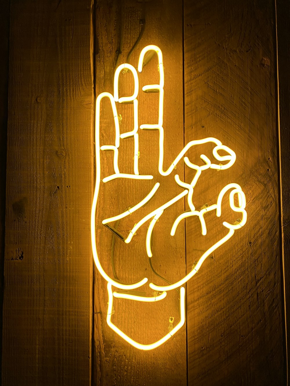 a neon sign with a hand on it