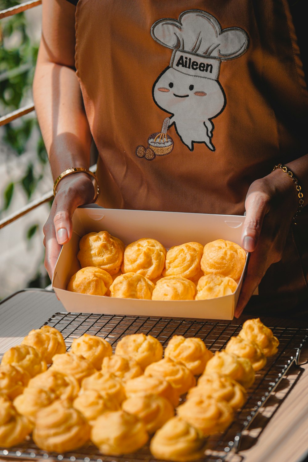 person holding tray of doughnuts