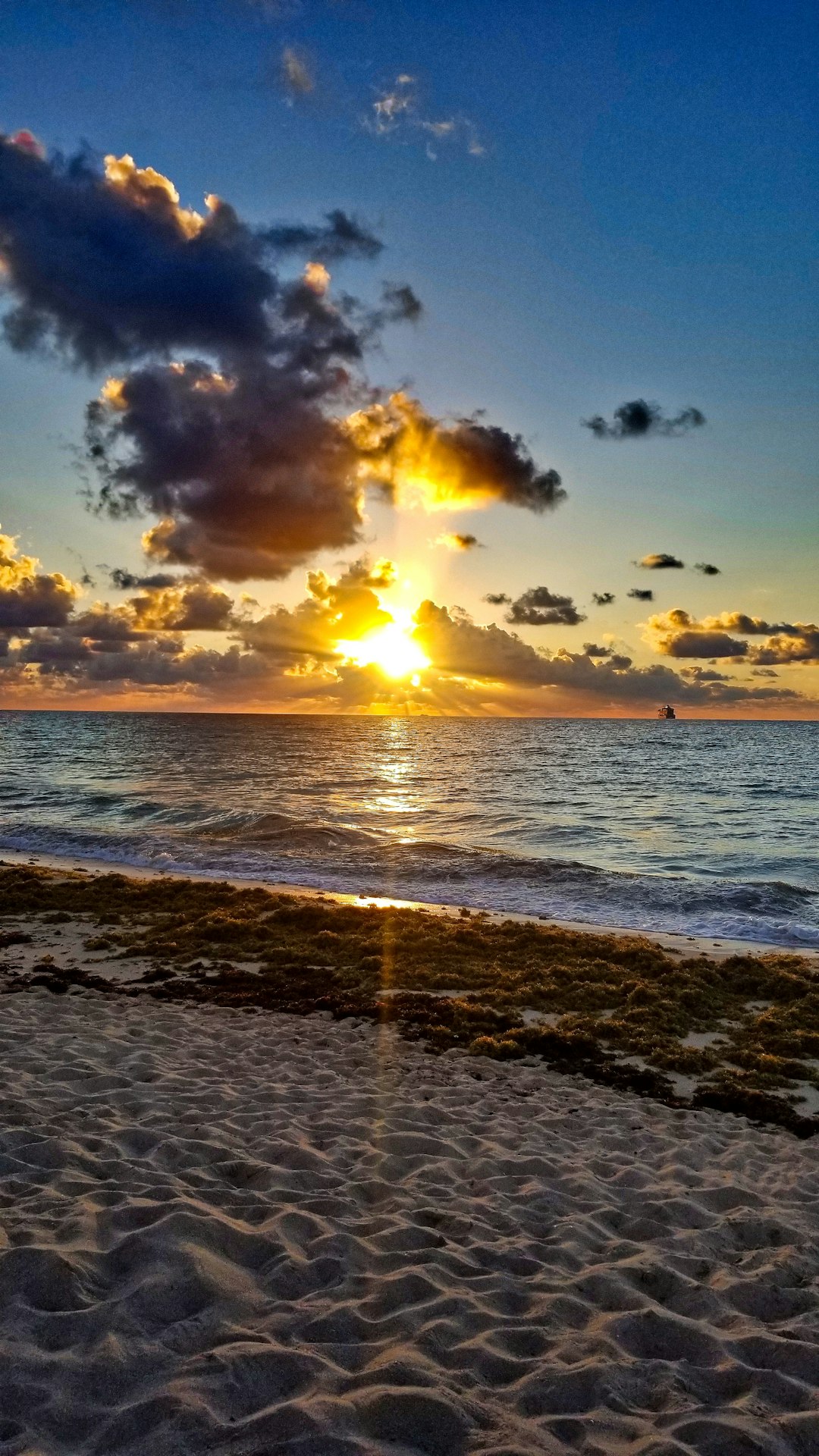 sea waves crashing on shore during sunset