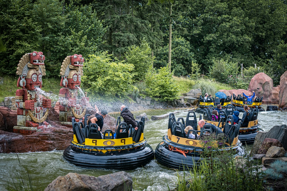 people riding on yellow boat on river during daytime