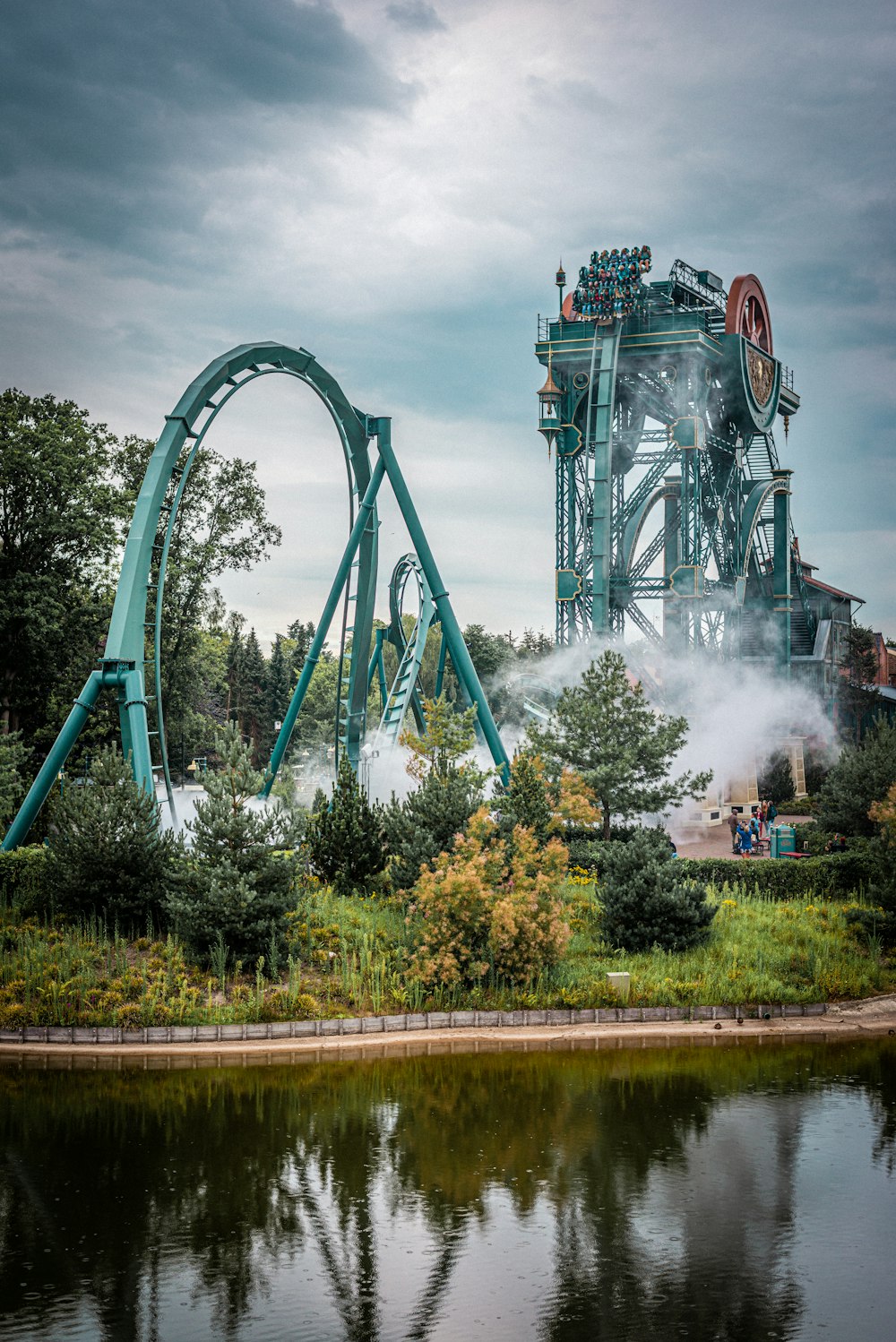 blue roller coaster on green grass field during daytime