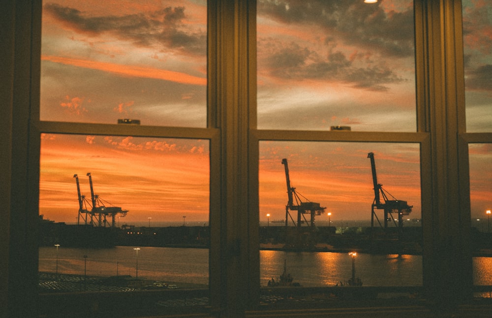 silhouette of people standing on dock during sunset