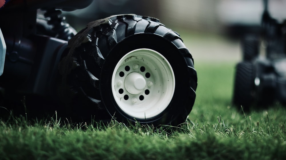 white and black wheel on green grass