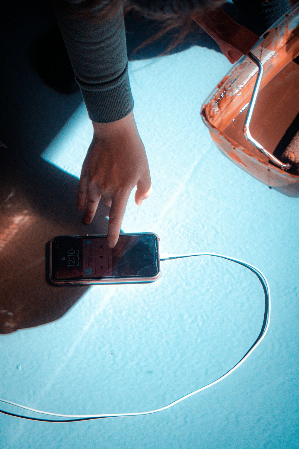 black smartphone on blue table