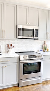 white microwave oven on white wooden cabinet