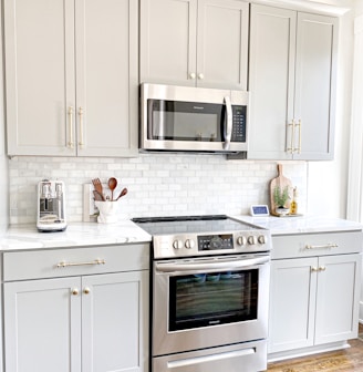 white microwave oven on white wooden cabinet