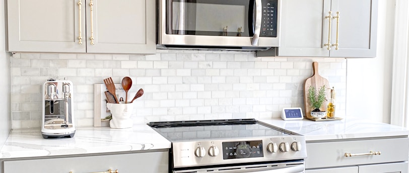 white microwave oven on white wooden cabinet