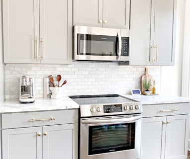 white microwave oven on white wooden cabinet