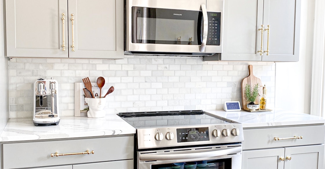 white microwave oven on white wooden cabinet